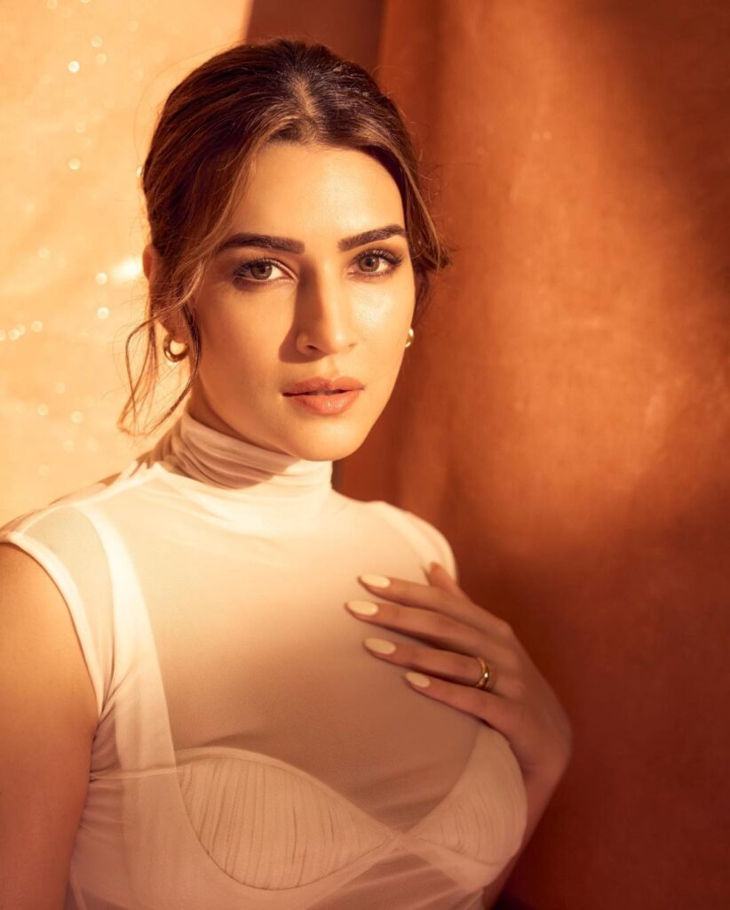 In this captivating photo, Kriti Sanon, the acclaimed Indian actress, shines with her captivating presence. Her radiant smile and confident posture convey a sense of grace and allure, making this image truly enchanting